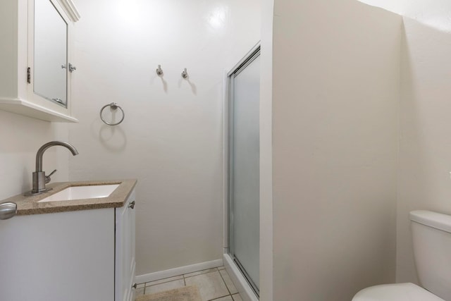 534 Kaikoo Pl, Wailuku, HI 96793 - bathroom featuring toilet, a shower stall, vanity, tile patterned flooring, and baseboards