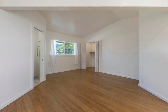 534 Kaikoo Pl, Wailuku, HI 96793 - unfurnished bedroom featuring lofted ceiling, light wood finished floors, and baseboards