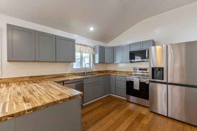 534 Kaikoo Pl, Wailuku, HI 96793 - kitchen featuring stainless steel appliances, wooden counters, a sink, vaulted ceiling, and gray cabinets
