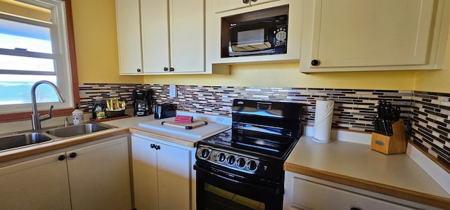 kitchen featuring decorative backsplash, black appliances, and sink