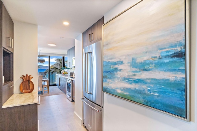 kitchen featuring light tile patterned floors and stainless steel appliances