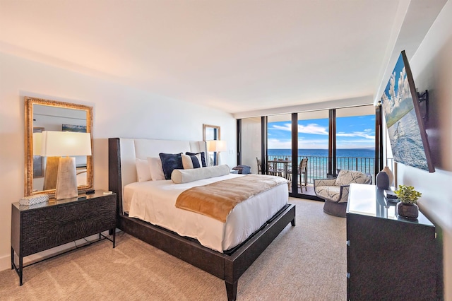 bedroom with light carpet, access to exterior, and floor to ceiling windows