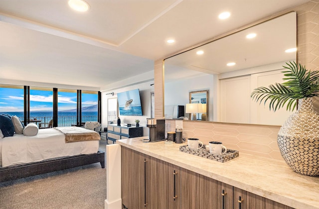 bedroom featuring carpet and expansive windows