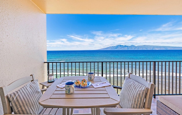 balcony with a water and mountain view and a beach view