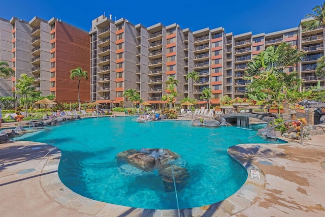 view of swimming pool with pool water feature