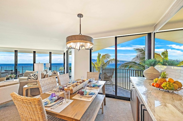 dining space with a chandelier and a water view