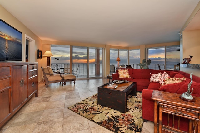 living room with a water view and floor to ceiling windows