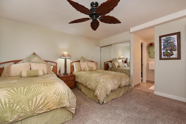 carpeted bedroom featuring a closet and ceiling fan