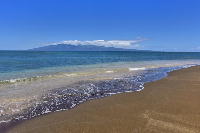 property view of water featuring a mountain view and a view of the beach