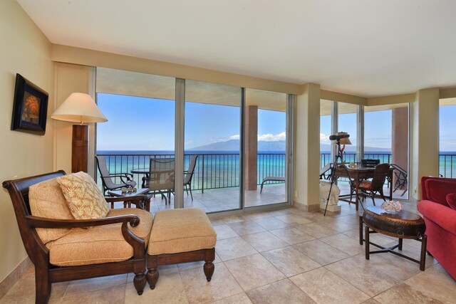 interior space with a water view and light tile patterned floors