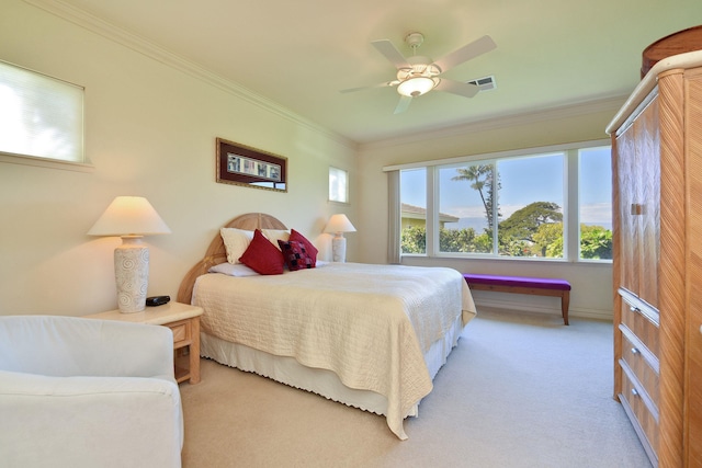 bedroom featuring visible vents, ornamental molding, ceiling fan, and light colored carpet