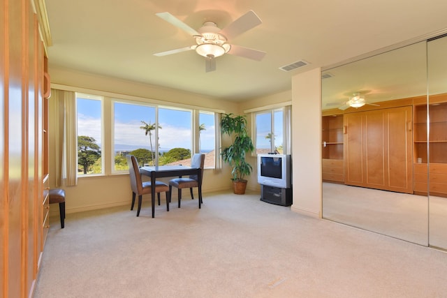 dining space with baseboards, a ceiling fan, visible vents, and light colored carpet