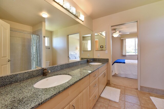 bathroom featuring double vanity, tile patterned floors, a sink, and ensuite bathroom