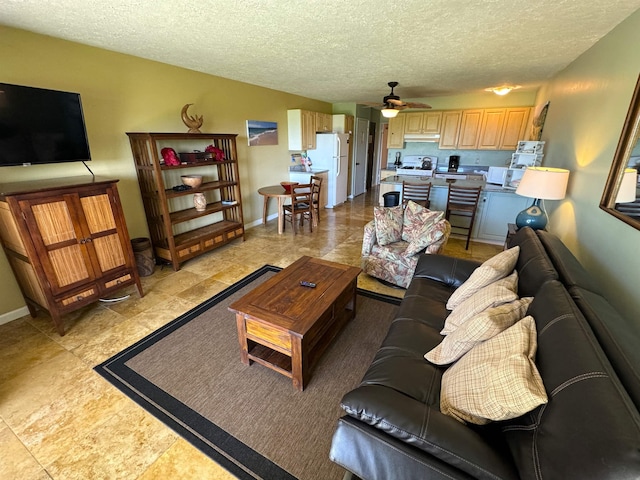 living room featuring a textured ceiling and ceiling fan