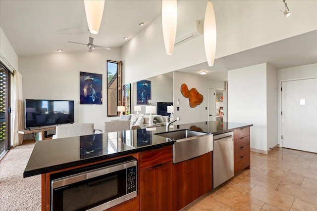 kitchen featuring a healthy amount of sunlight, appliances with stainless steel finishes, and open floor plan