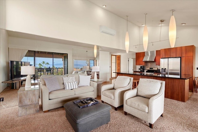 living room featuring a high ceiling, a wall mounted AC, and light colored carpet