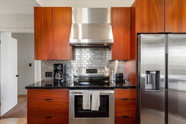 kitchen featuring tasteful backsplash, stainless steel appliances, brown cabinets, and wall chimney exhaust hood