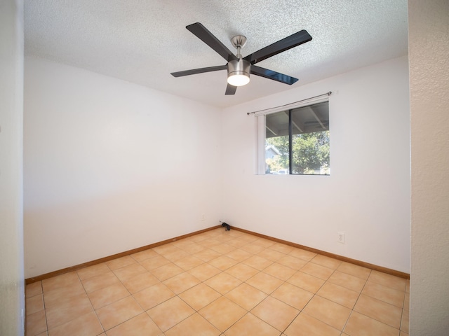 tiled spare room featuring ceiling fan and a textured ceiling