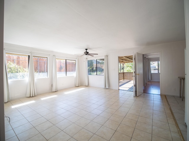 tiled empty room featuring ceiling fan