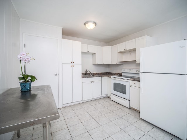 kitchen with sink, white appliances, light tile patterned floors, and white cabinets