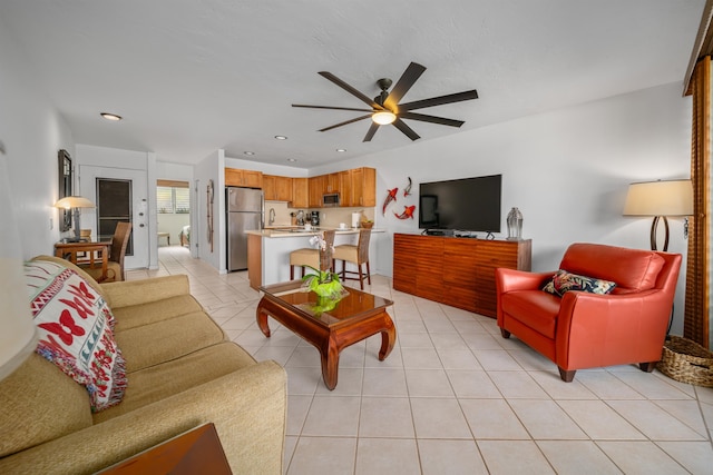 tiled living room with sink and ceiling fan