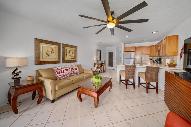 tiled living room featuring ceiling fan