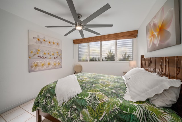 tiled bedroom featuring ceiling fan