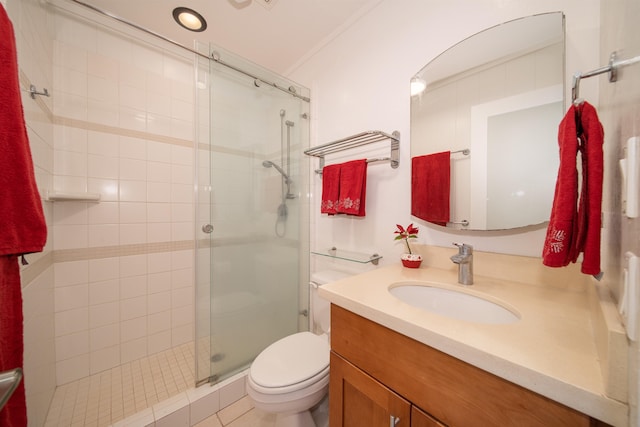 bathroom featuring vanity, a shower with shower door, ornamental molding, toilet, and tile patterned flooring