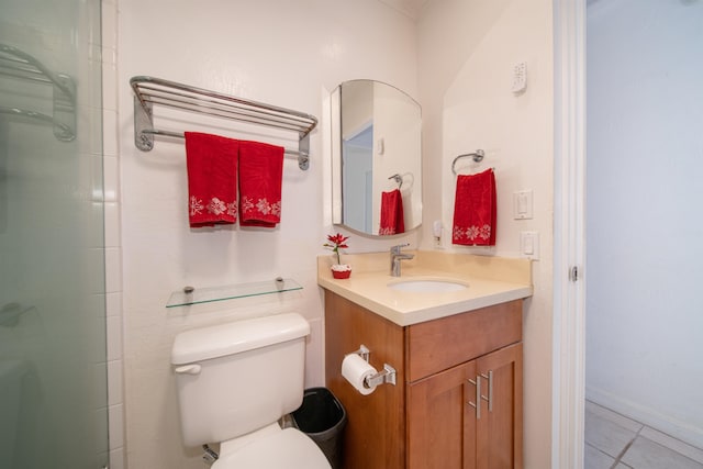 bathroom featuring vanity, an enclosed shower, tile patterned flooring, and toilet