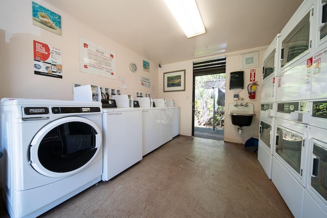 clothes washing area featuring sink, washing machine and dryer, and stacked washing maching and dryer