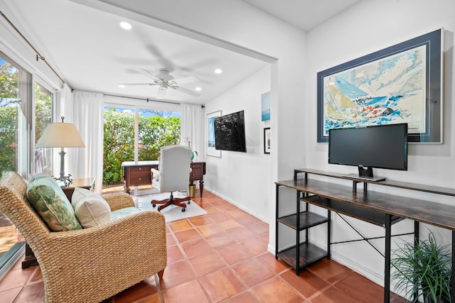 tiled living room with ceiling fan, a healthy amount of sunlight, and vaulted ceiling