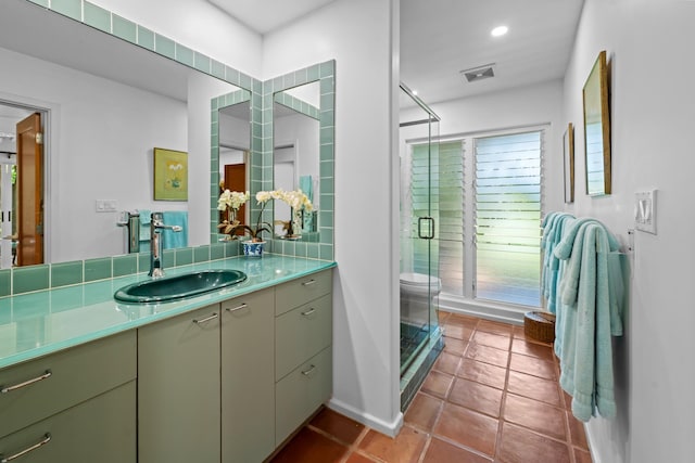 bathroom with an enclosed shower, vanity, tile floors, and toilet