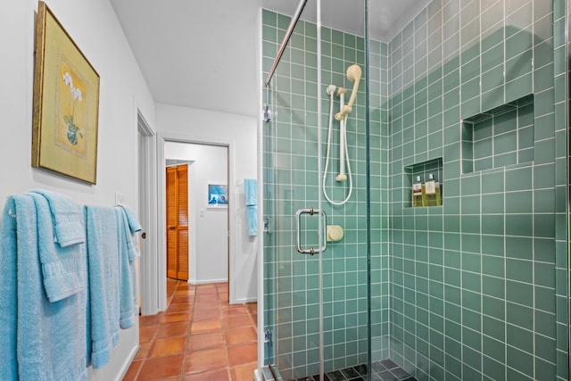 bathroom with tile floors and a shower with shower door