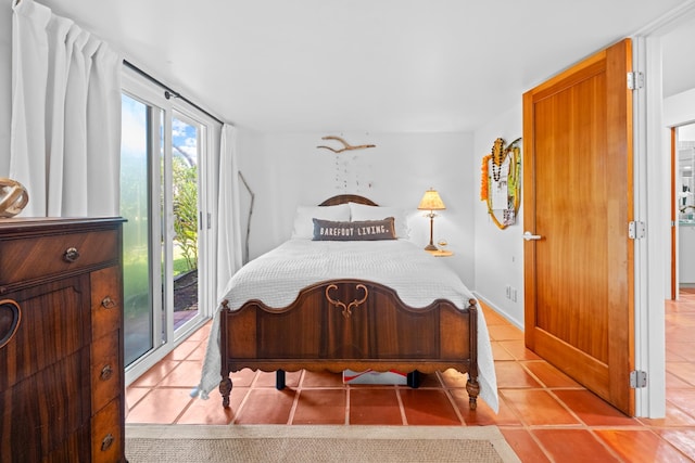 bedroom with light tile flooring and access to exterior