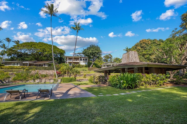 view of yard featuring a fenced in pool and a patio area