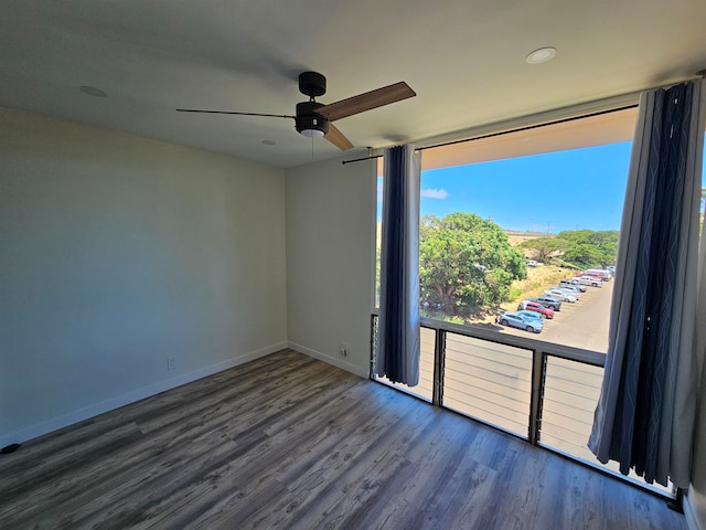 unfurnished room with dark wood-type flooring and ceiling fan