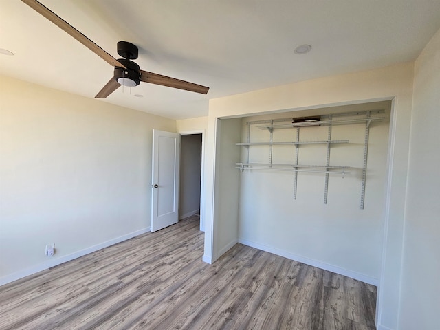 unfurnished bedroom featuring a closet, light wood-type flooring, and ceiling fan