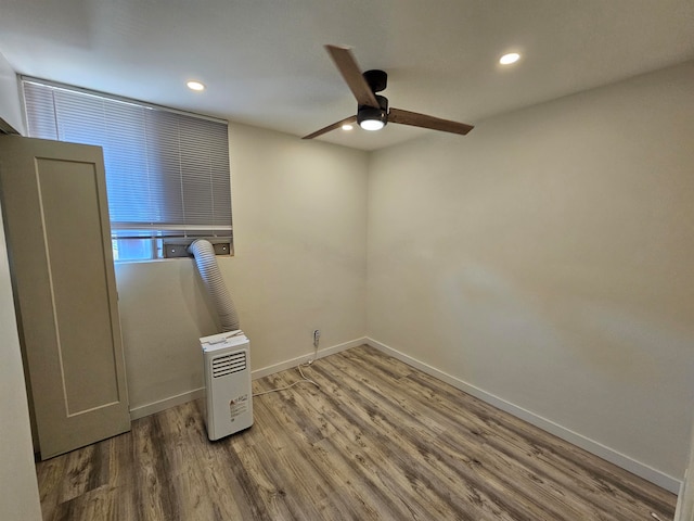 spare room featuring hardwood / wood-style floors and ceiling fan