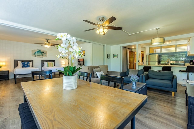 dining room with hardwood / wood-style floors and sink