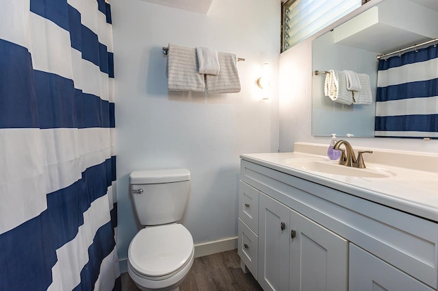 bathroom with hardwood / wood-style floors, vanity, and toilet