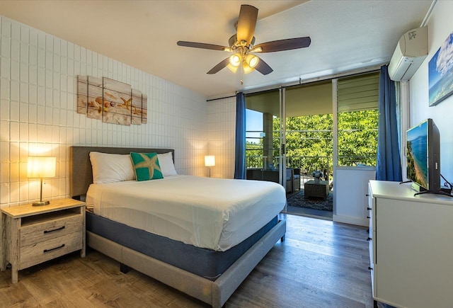 bedroom featuring ceiling fan, tile walls, dark wood-type flooring, and a wall mounted AC