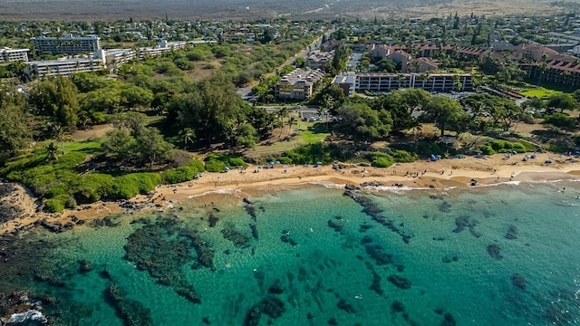 birds eye view of property with a beach view and a water view