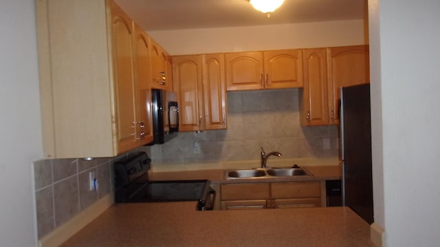 kitchen with black appliances, sink, light brown cabinetry, and tasteful backsplash