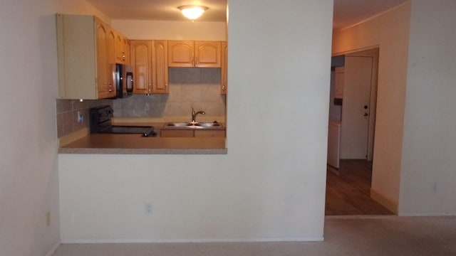 kitchen with black appliances, backsplash, light brown cabinets, and sink