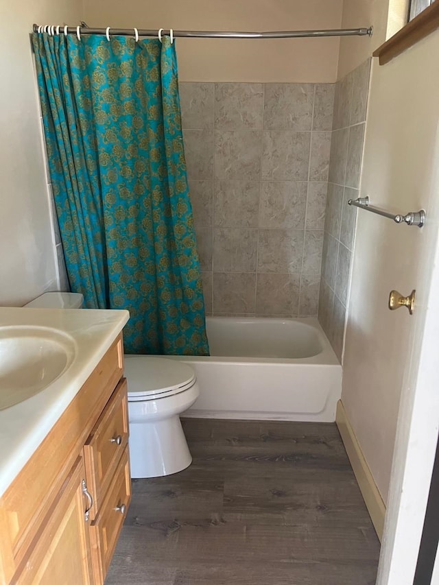 full bathroom with wood-type flooring, vanity, toilet, and shower / bath combo with shower curtain