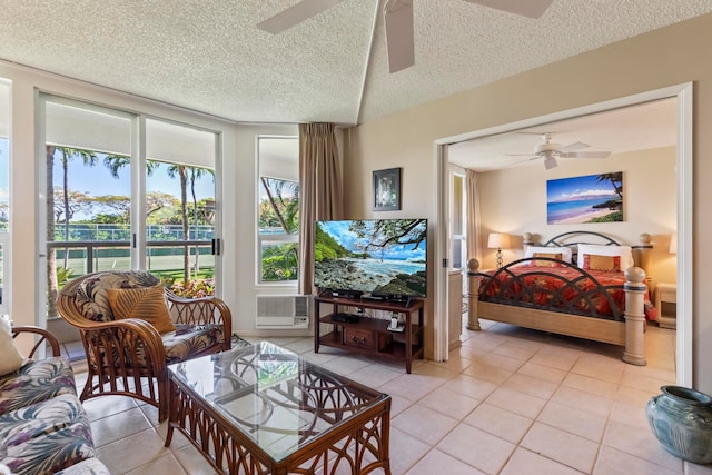 interior space featuring light tile patterned floors, ceiling fan, and a textured ceiling