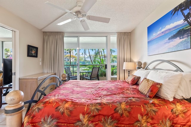 bedroom featuring multiple windows, a textured ceiling, access to exterior, and ceiling fan