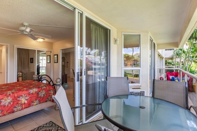 balcony featuring outdoor dining area and a ceiling fan