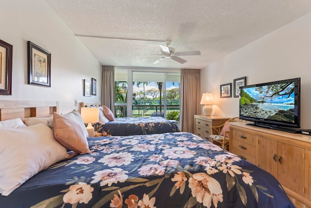 bedroom with a textured ceiling and ceiling fan