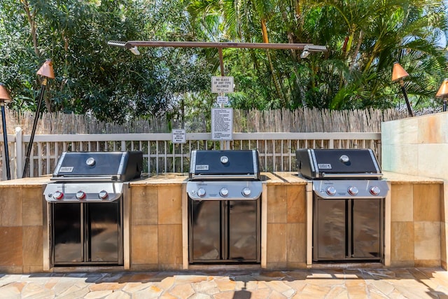 view of patio with fence and area for grilling